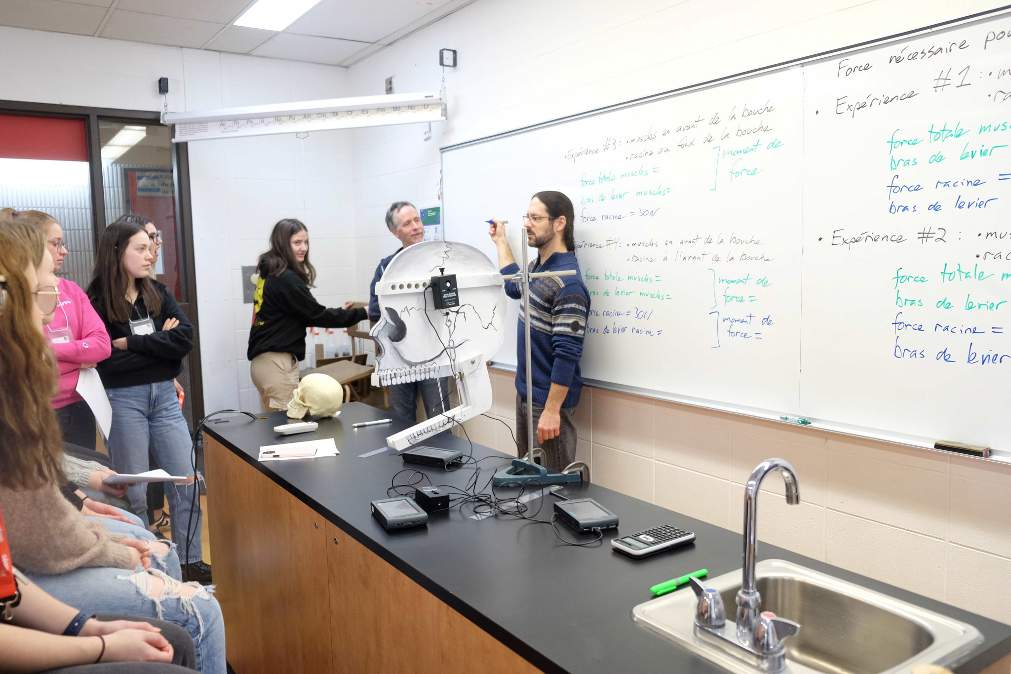 explication d'un professeur au tableau devant sa classe